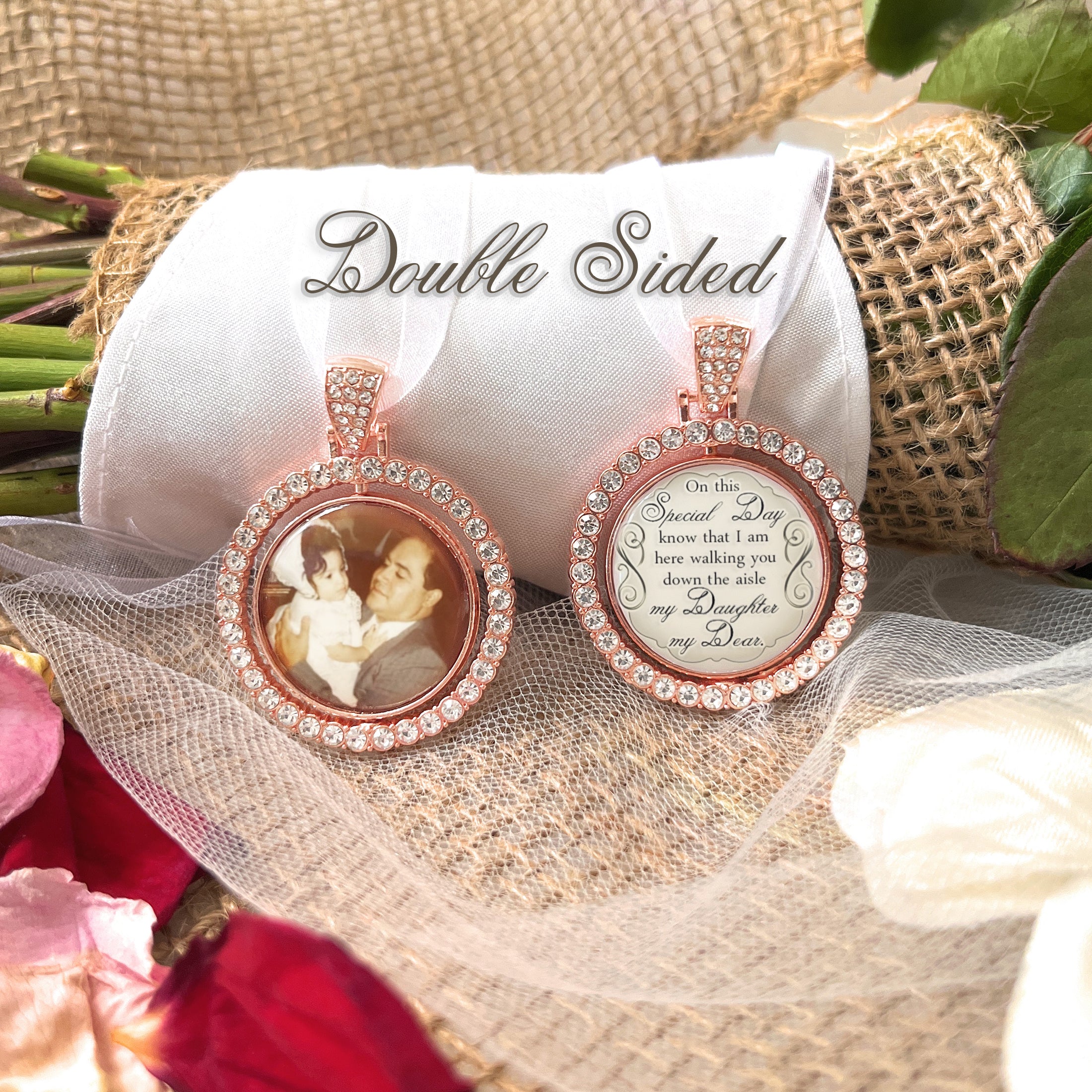 Memorial bridal bouquet charm comes with photo and custom saying. Image size is roughly 1 inch. Pendant has a rotating center and is double sided. The outer edge is surrounded in rhinestones. The saying is: On this special day Know that I am here walking you down the aisle my daughter my dear.
