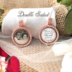 Memorial bridal bouquet charm comes with photo and custom saying. Image size is roughly 1 inch. Pendant has a rotating center and is double sided. The outer edge is surrounded in rhinestones. The saying is: Those we love don't go away they walk beside us every day!
