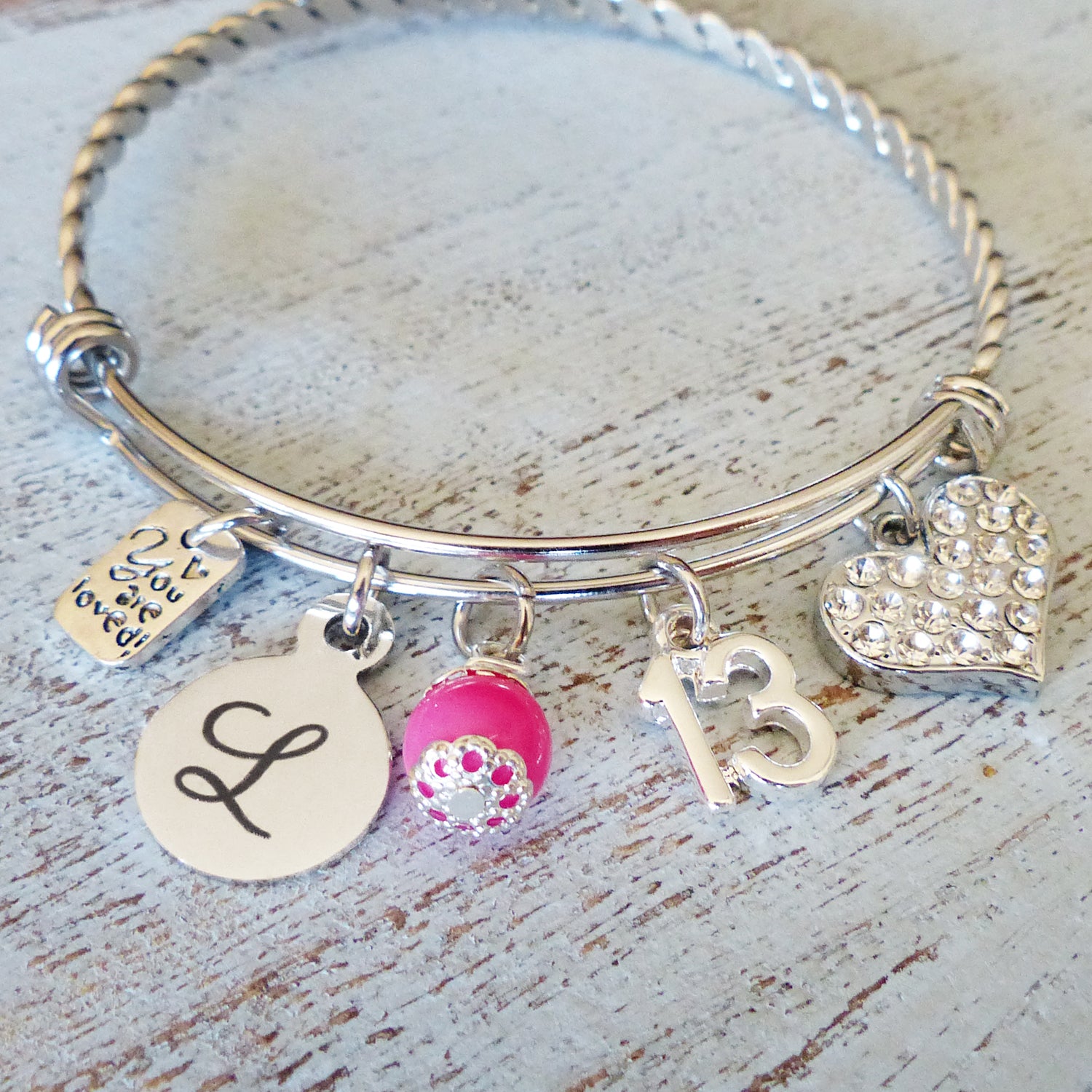 13 year old personalized bangle bracelet with heart and you are loved charms. Custom letter