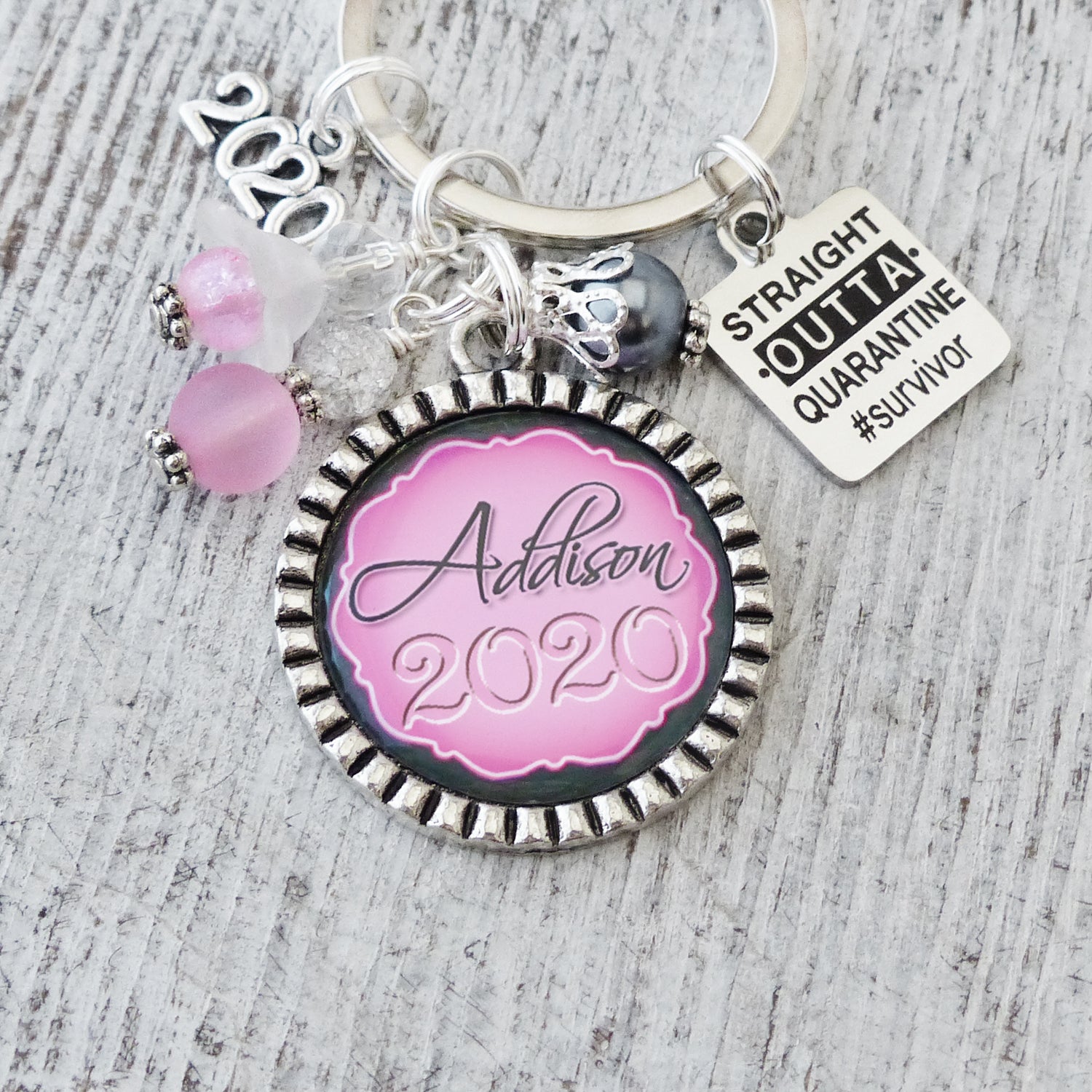 personalized name 2022 graduation keychain with straight outta quarantine survivor charm and year charm. Pink and grey