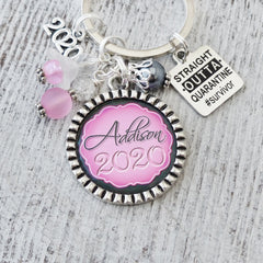 personalized name 2022 graduation keychain with straight outta quarantine survivor charm and year charm. Pink and grey